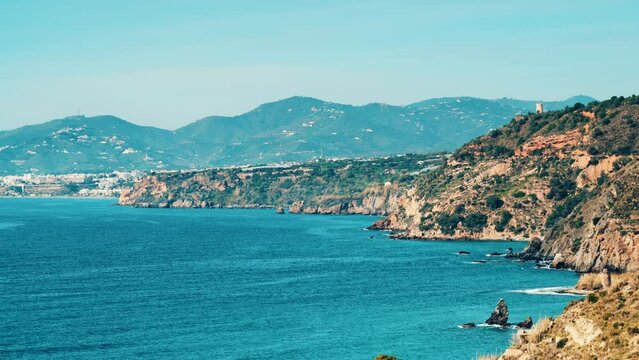 Coastal landscape. Cliffs of Maro Cerro Gordo Natural Park with tower Maro, Malaga province, Costa Del Sol, Andalusia, Spain.