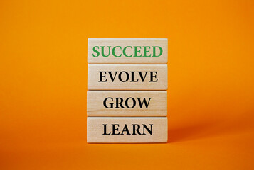 Learn Grow Evolve Succeed symbol. Wooden blocks with words Learn Grow Evolve Succeed. Beautiful...