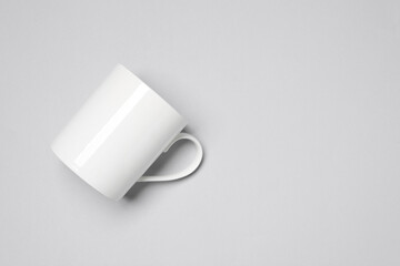 One white ceramic mug on light background, top view and space for text