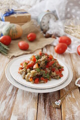 A warm salad of baked eggplant and peppers with tomatoes