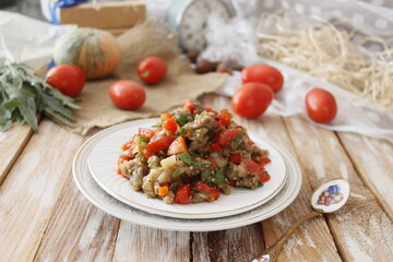 A warm salad of baked eggplant and peppers with tomatoes