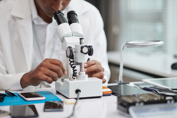 Technician looking at hard drive through microphone