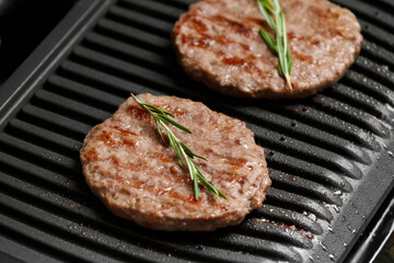 Burger cutlets are fried on a smart electric grill, homemade burgers.