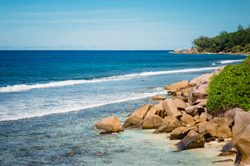 Obraz premium Big granite rocks on the Grand Anse beach. La Digue island, Seychelles. Tropical landscape with sunny sky.