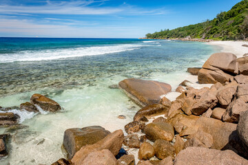 Fototapeta na wymiar Big granite rocks on the Grand Anse beach. La Digue island, Seychelles. Tropical landscape with sunny sky.