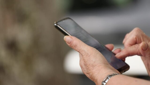 close-up of senior woman's hand with mobile phone
