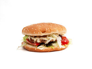Homemade hamburger on a white background. Delicious burger with cheese, bacon, onion, cucumber, tomato and lettuce on a white background.