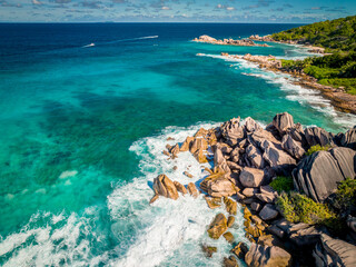 Aerial view Top down seashore. Waves crashing on rock cliff. Beautiful dark sea surface in sunny day summer background Amazing seascape top view seacoast at La Dique Grand l'Anse, Seychelles
