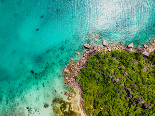 Praslin Seychelles tropical island with withe beaches and palm trees. Aerial view of tropical paradise bay with granite stones and turquoise crystal clear waters of Indian Ocean