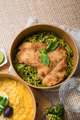 Green sauce pesto pasta with chicken fillet Food buffet peruvian table Assorted dishes gourmet cuisine Peru traditional 