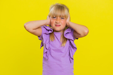 Dont want to hear, listen. Frustrated annoyed irritated young cute school girl covering ears,...