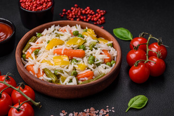 Delicious fresh white boiled rice with vegetables carrots, peppers and asparagus beans on a ceramic plate