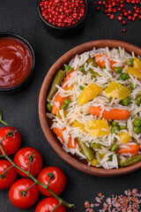 Delicious fresh white boiled rice with vegetables carrots, peppers and asparagus beans on a ceramic plate