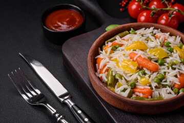 Delicious fresh white boiled rice with vegetables carrots, peppers and asparagus beans on a ceramic plate