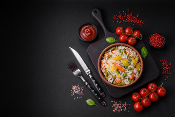 Delicious fresh white boiled rice with vegetables carrots, peppers and asparagus beans on a ceramic plate