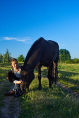 Beautiful girl with horse on the sunset