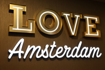 Text "Love Amsterdam" on wall in department store in Amsterdam