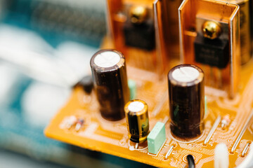 Capacitors arranged on circuit board with electronic components showcase intricate modern devices.