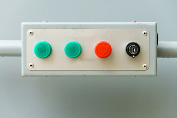 Multi-colored mechanical buttons and a keyhole for turning on the mechanism. A dashboard with buttons for controlling the drive of the manipulator and special equipment at the factory.