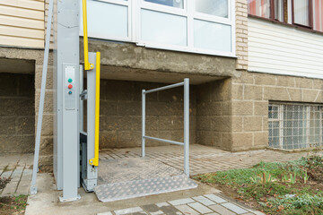 Outdoor elevator at the entrance of the house for people with disabilities. Modern electric...