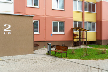Well-groomed and clean courtyard of a multi-storey building. View of the entrance and the first floor of a residential building. Developed and safe for recreation infrastructure