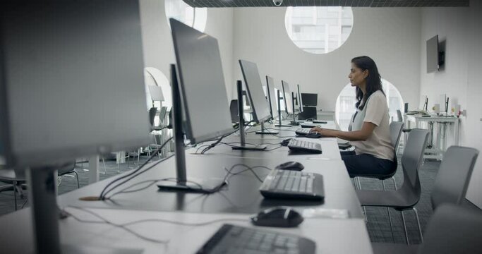 Businesswoman Working on Computer in Empty Corporate Office