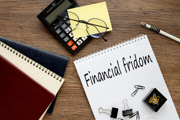 Financial Freedom, financial concept. open notebook on the work table. calculator