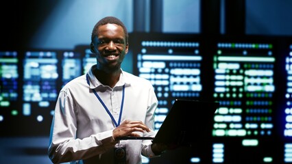 Computer scientist using tablet to analyze server cabinets providing computing resources and storage, enabling artificial intelligence to process massive datasets for training and machine learning