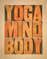 yoga, mind, body word abstract - text in letterpress wood type on handmade paper, meditation, wellness and lifestyle concept