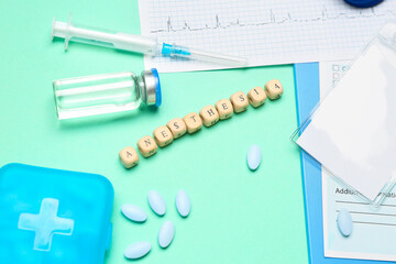 Word ANESTHESIA with medical supplies on green background, closeup