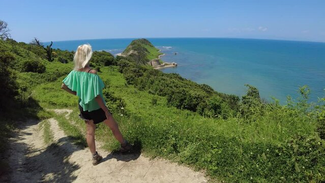 Woman tourist at Cape of Rodon in Albania. Albanian hero Skanderbeg built a castle on cape to defend against the Ottoman Turks. Rodon Castle was later used by Holy See of Vatican and French Empire.