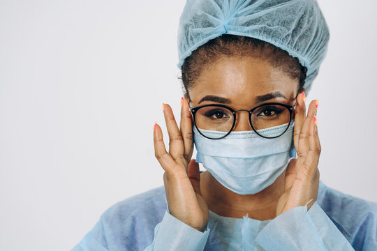 Portrait of young female african american doctor or nurse woman on medical protective wear with mask