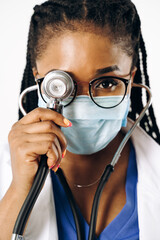 beautiful african american female physician wearing mask with stethoscope