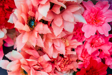 A bouquet of colorful artificial flowers close-up. Floristry for a holiday or wedding. Artificial flowers for a grave or funeral.