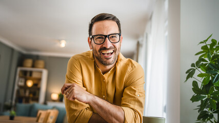 One adult man with eyeglasses stand at home happy smile