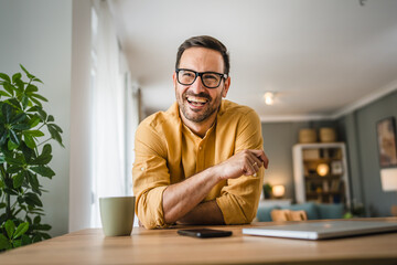 One adult man with eyeglasses stand at home happy smile