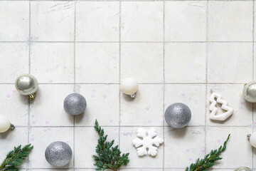Different Christmas decorations on white tile background