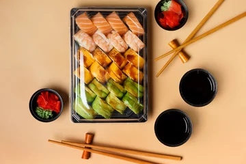 Poster Set of sushi rolls in plastic packages on a light background, top view. © Наталья Марная