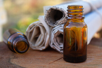 essential oil bottles with herbs on a wooden table 
