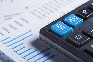 calculator and financial charts. Investment and capital accumulation concept