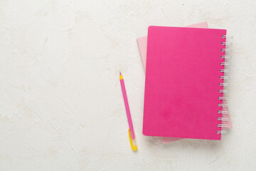 Notebooks with stationery on concrete background, top view