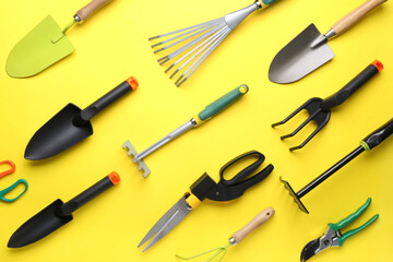 Set of different gardening tools on yellow background