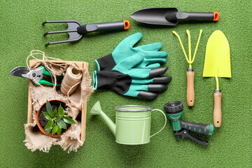 Composition with gardening tools on green grass background