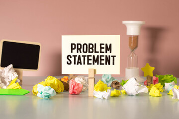 wooden cubes are scattered near the notepad with text. problem statement