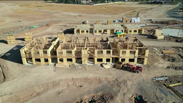 Casa Grande, Arizona, USA- June 4, 2023:  Aerial view of a new apartment complex at various stages of construction including site preparation, underground utilities, and post tensioned rods. 