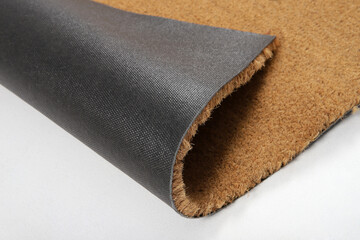 Natural brown coconut fiber doormat. Plain natural dry carpet and dirt outside your entrance, Detail, closeup of fiber and base on white background