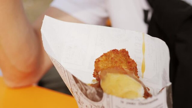 Fried fish and chips in a paper cone on festival market fodd truck. 