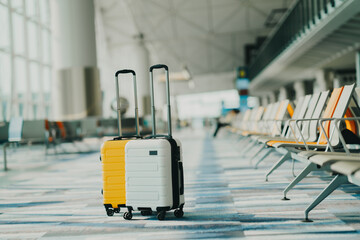 Two suitcases in an empty airport hall, traveler cases in the departure airport terminal waiting for the area, vacation concept, blank space for text message or design