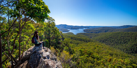 hiker girl admiring the panorama of advancetown lake and springbrook national park as seen from the...
