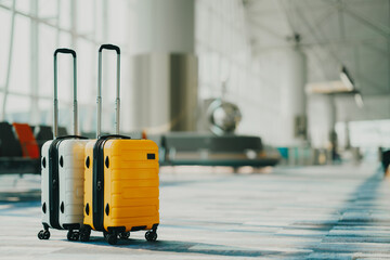 Two suitcases in an empty airport hall, traveler cases in the departure airport terminal waiting for the area, vacation concept, blank space for text message or design - Powered by Adobe